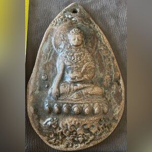 Hand made wall hanging ceramic Buddha.